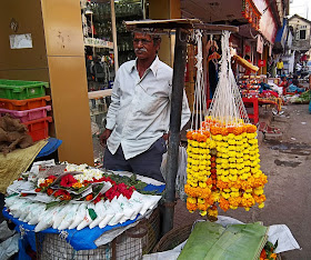 man selling flower garlands