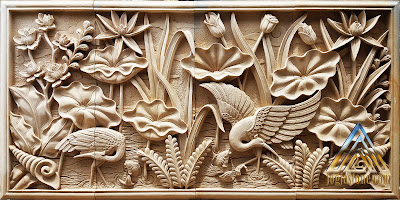 Relief burung bangau dan bunga lotus dibuat dari batu alam paras jogja atau batu paras putih