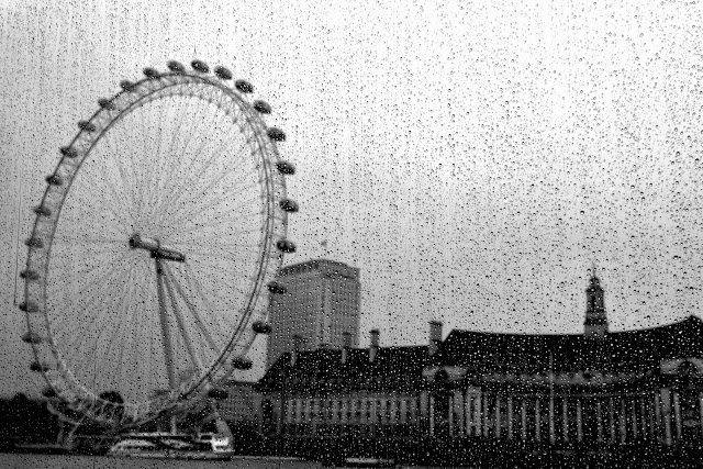 A rainy view of the London Eye from the Thames river boat