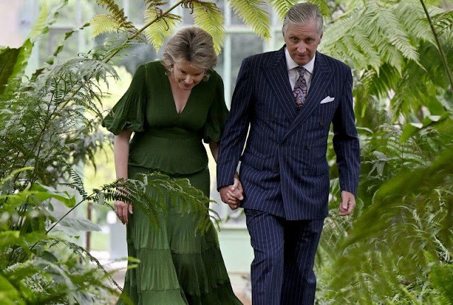 Queen Mathilde wore a new green pleated tiered twill midi dress by Zimmermann. Green earrings. Crown Princess Elisabeth