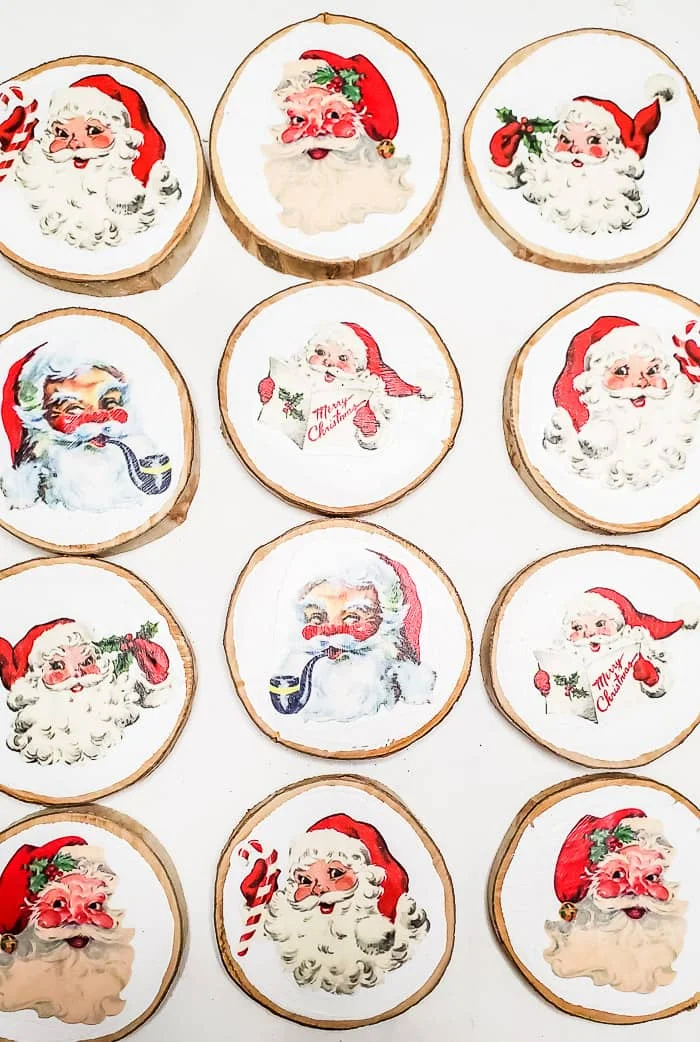 white wood slices with Santa faces