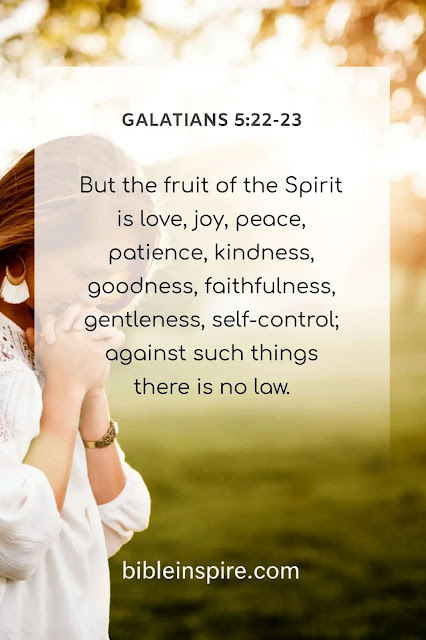 A woman praying in a soft light, accompanying the Bible verse Galatians 5:22-23, which describes the Fruit of the Spirit, an essential teaching for understanding the Holy Spirit's work after Pentecost.