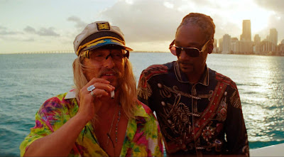 Movie still for Harmony Korine's 2019 film The Beach Bum Matthew McConaughey and Snoop Dogg smoke marijuana on a boat out at sea