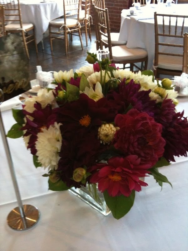 We used seasonal dahlias in white red and burgundy to create centerpieces