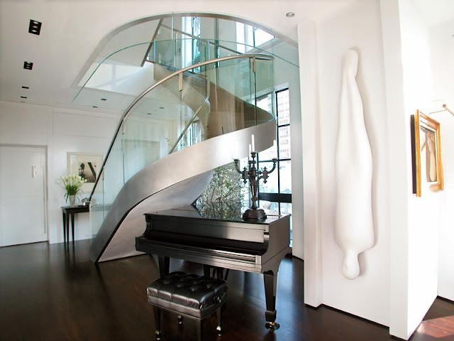 Photo of amazing modern staircase with glassy railing with the piano under the staircase