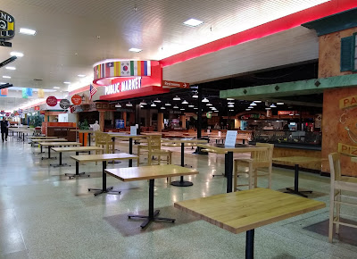 The deserted mall food court, devoid of diners