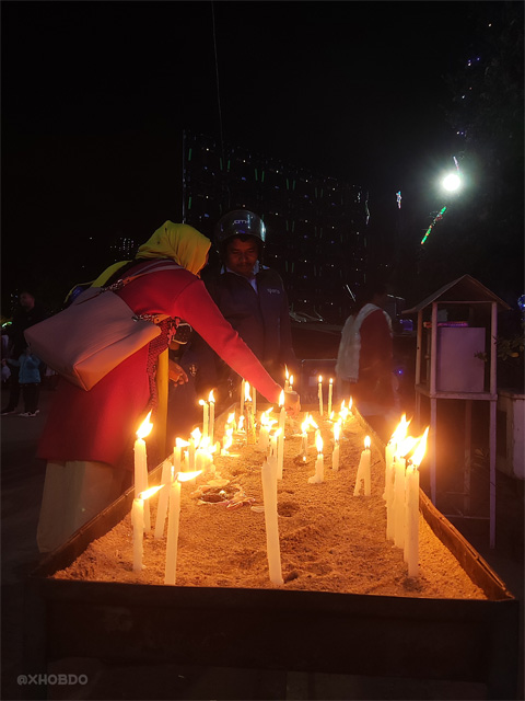 People lighting candles at Saint Joseph Church