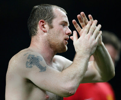 Celtic cross tattoo on a football athlete arm.