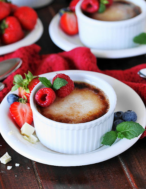 White Ramekin of White Chocolate Creme Brulee Topped with Raspberries Image