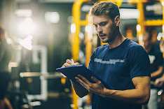 Man writing in workout journal