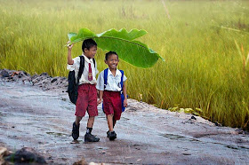 Using Banana leaf as umbrella in rain is indeed clever or cute may be