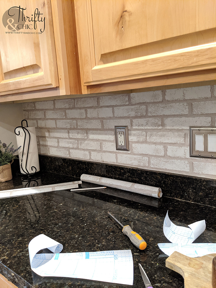 faux brick backsplash, diy brick backsplash, diy brick kitchen backsplash, cottagecore kitchen, wood kitchen cabinets, brick wall kitchen, brick peel and stick wallpaper, knotty alder cabinets, wood and black kitchen