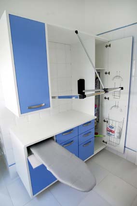 Laundry Cupboard image of a small white laundry room with bright 