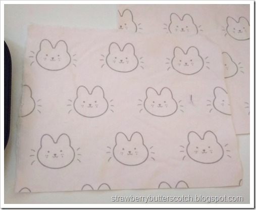 Close up of the cute fabric, it's a pink flannel with kawaii bunnies all over.