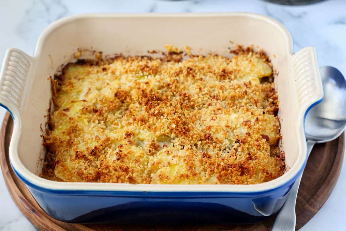 Potato Gratin with Gruyère, Bacon, and Leeks in a casserole pan.