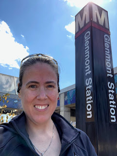 Photo of me outside standing in front of a Glenmont Station sign