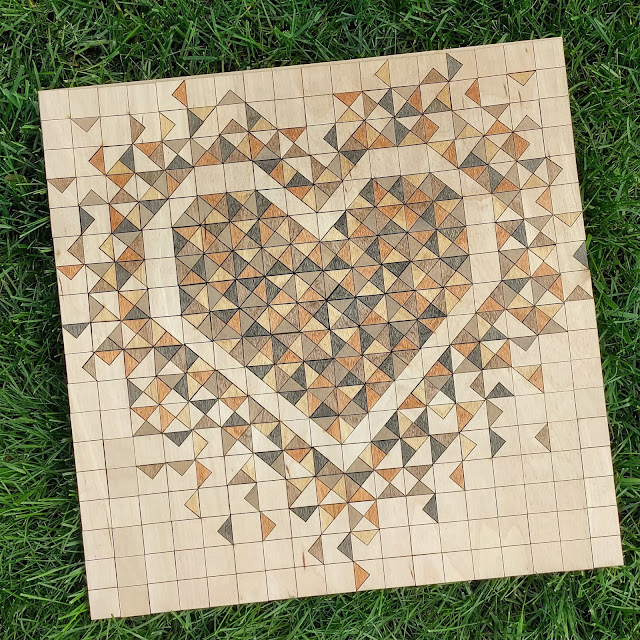 A laser cut wood Exploding Heart quilt