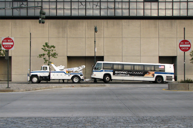 Heavy tow truck recovering a bus, 12th Avenue West, New York