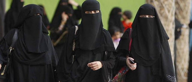 If a woman travels abroad, what is the ruling on hijab with her face uncovered?