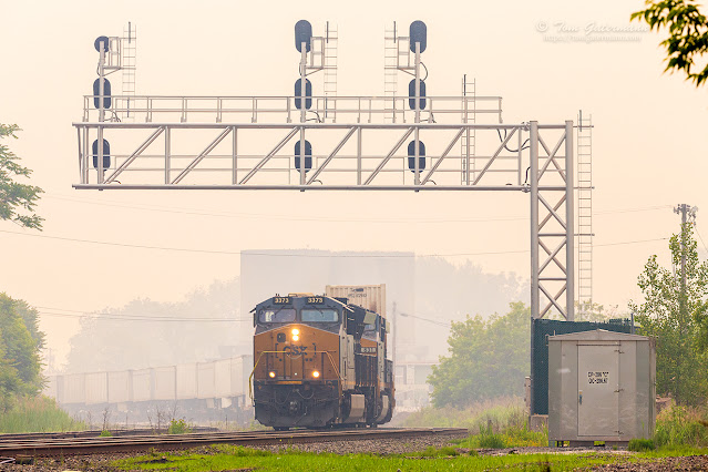 Intermodal train, I009-06, led by CSXT 3373, is coming west at CP-286. I009 is departing DeWitt Yard, which is just around the curve past the old NYC coaling towers in the background.