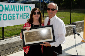 Jane Lundquist, executive vice president of Rockland Trust, and Ed Hurley, president of the Hockomock Area YMCA, with the Rockland Trust Family Splash Park dedication plaque