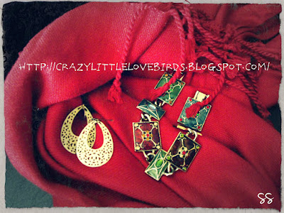 Red scarf, gold earrings, and a colorful bracelet