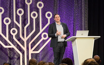 Man addressing audience from RootsTech stage