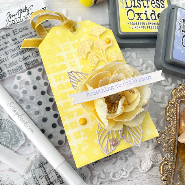 Yellow mixed media tag created with Tim Holtz Mr. Rabbit stamp, Squeezed Lemon Distress Oxide, and Prima Marketing In Full Bloom collection.