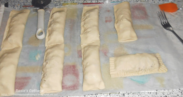 Let's make some super easy sausage rolls - The puff pastry is then folded over, making a little sausage and onion parcel, and I used a fork to seal all of the open sides closed.😊