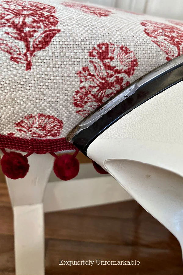 Using An Iron To Add Trim To Upholstery by pressing it against the top of the trim