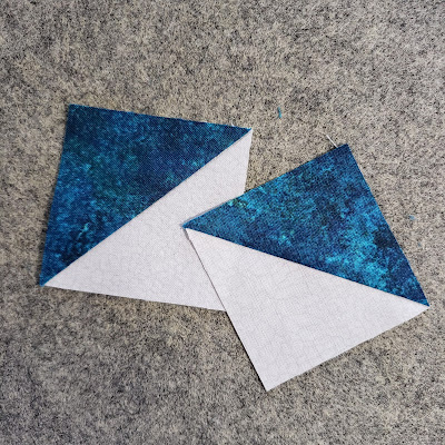 two white and dark teal half-square triangle square patchwork units