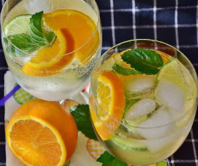 Ice cold water with sprigs of mint and orange slices