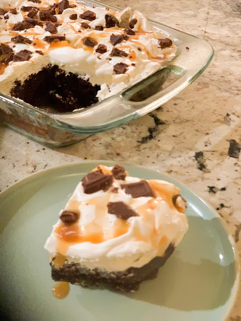 Irresistible Symphony Cake, devil's food chocolate cake mix, infused with sweetened condensed milk, topped with whipped topping, drizzled with caramel ice cream topping, and sprinkled with chopped chocolate symphony candy bars.  Delectable.