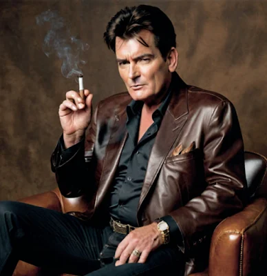 Charlie Sheen wearing brown leather blazer smoking cigar sitting down from the knees up