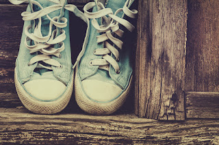 A pair of old sneakers that, like old habits, are hard to toss out unless you work through developing and adopting new habits through action learning