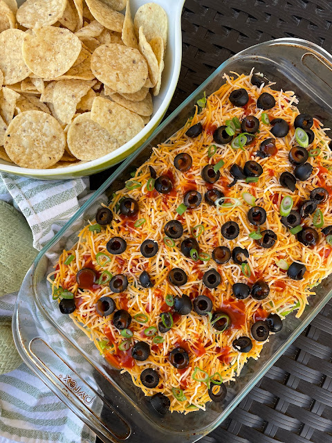 Easy layered taco dip with tortilla chips.
