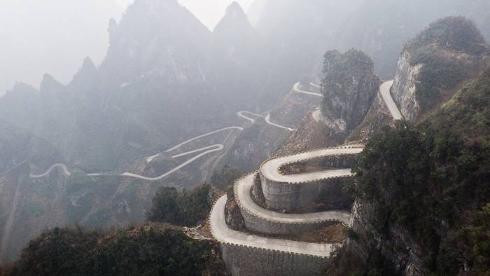 Jutting out from a sheer cliff 1,430 meters high, the glass skywalk in Zhangjiajie National Forest Park offers sightseers terrifying thrills and clear view of the mountains below as they tread nervously across the 60 meter long bridge encircling the vertical cliffs of Tianmen Mountain in Hunan province. The 3ft-wide, 2.5in thick glass walkway is so scary that sightseers are requested to wear cloth slip-ons over their shoes when they cross the skywalk, presumably to make the job easier for the cleaners.