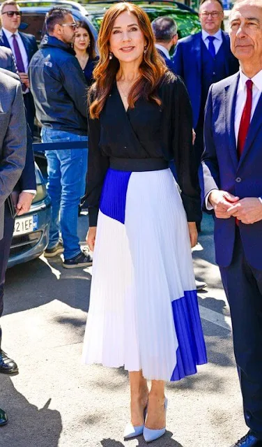 Crown Princess Mary wore a pleated chiffon midi skirt by Designers Remix, and a black v-neck silk blouse by Julie Fagerholt