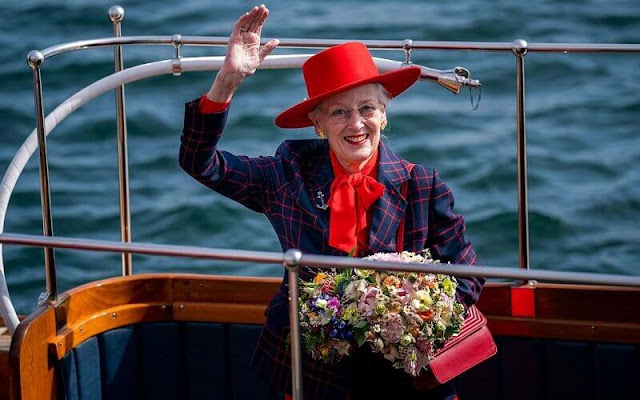 Queen Margrethe officially boarded the royal yacht Dannebrog. The Queen wore a red dress, and navy printed blazer, and red hat