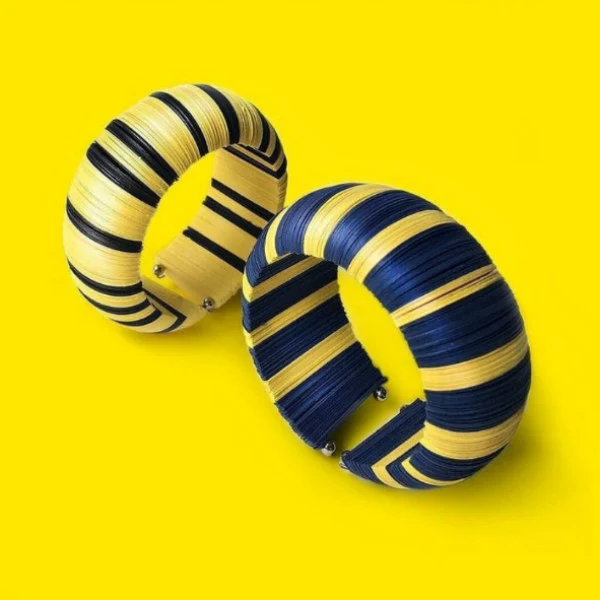 pair of striped cuff bracelets composed of navy and yellow paper discs