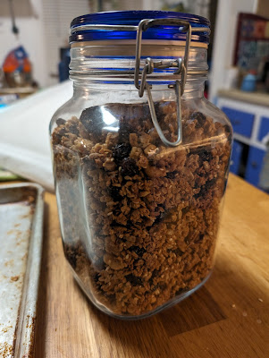 My homemade vegan Seven Stars Bakery granola in a glass jar with blue lid, from my copycat recipe!