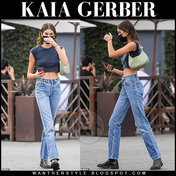 Kaia Gerber in cropped top, jeans and black ankle boots