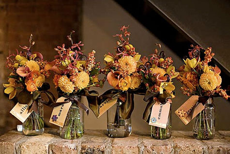 Think mason jars filled with floral arrangements wicker chairs 