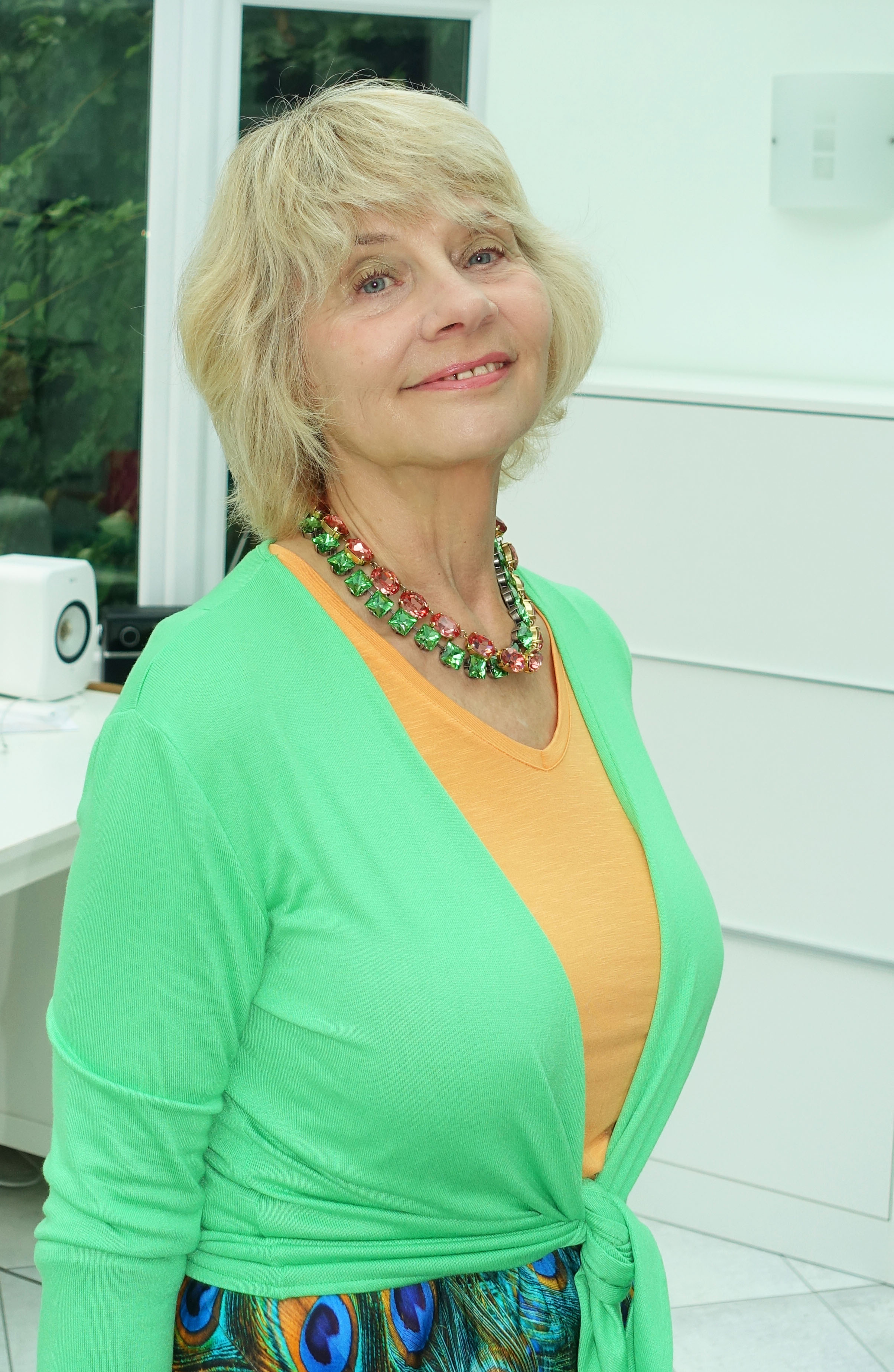 You will hopefully never be invisible with bright colours like these over 50.  Peacock skirt with bright apricot and fresh green worn by Gail Hanlon of Is This Mutton.