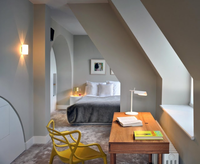 Bedroom with wooden desk and yellow chair 