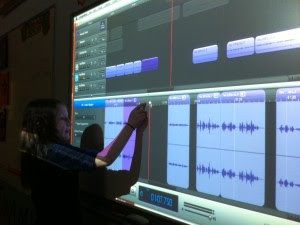 Child editing a podcast with a SMART board