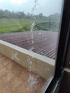 Water pouring off the balcony roof