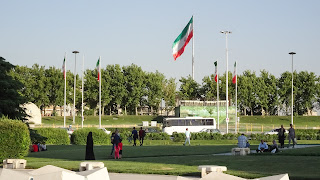 Locals eat and relax around Azadi