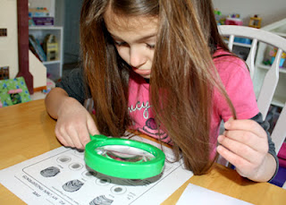 Finally, Tessa used a hand lens to closely examine her fingerprints. She correctly concluded that most of her prints are of the loop variety. She has a few arches as well. Tessa was bummed because she really wanted them all to be whorl shaped. Luckily, I have one whorl, so that cheered her up a bit.