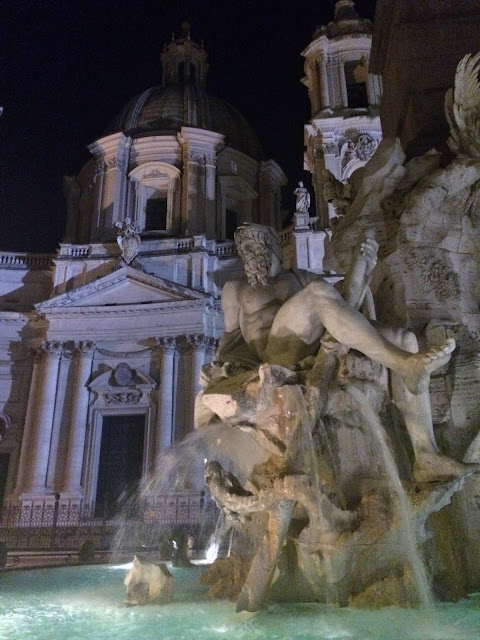 Bernini Fountain lit up in Rome's Piazza Navona at night, Rome Italy